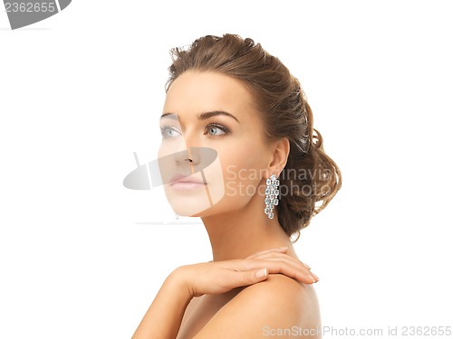 Image of woman wearing shiny diamond earrings