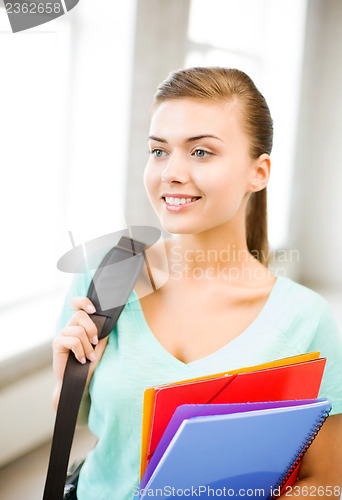 Image of student girl with school bag and color folders
