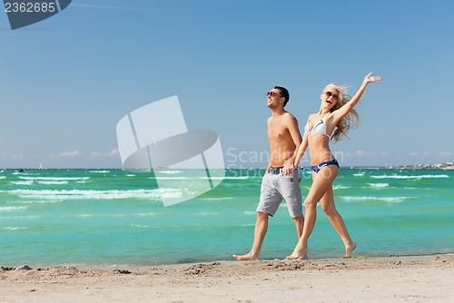 Image of couple walking on the beach