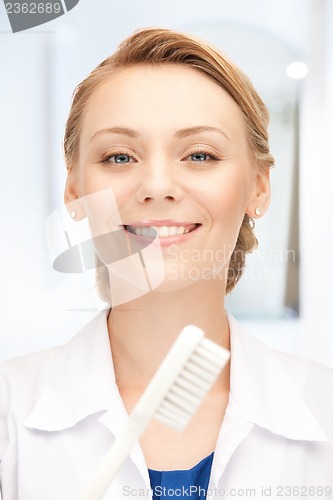 Image of attractive female doctor with toothbrush