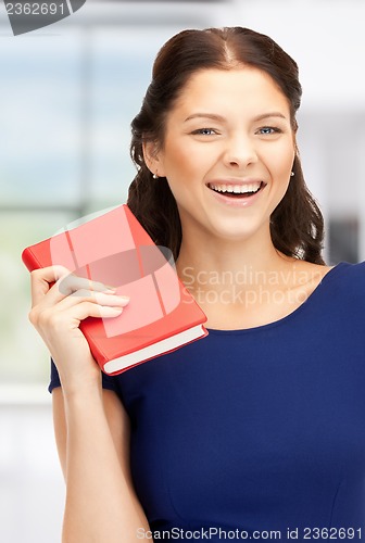 Image of happy and smiling woman with book