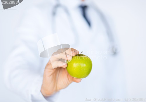 Image of male doctor with green apple