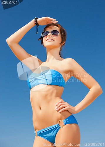 Image of woman in bikini and sunglasses