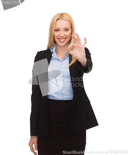 Image of young businesswoman showing ok sign