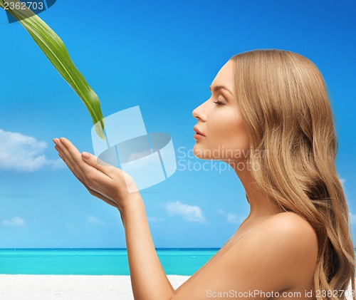 Image of woman with green leaf