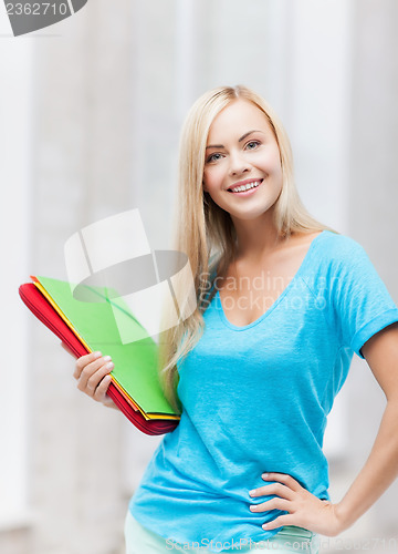 Image of smiling student with folders