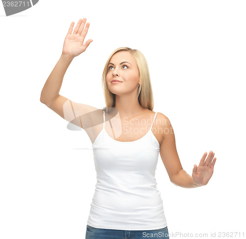 Image of woman in white t-shirt pressing imaginary button