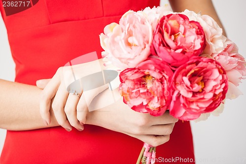 Image of woman hands with flowers and ring