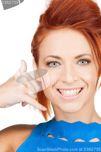 Image of woman making a call me gesture