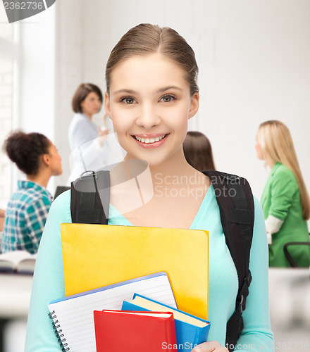 Image of student girl with school bag and notebooks