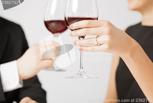 Image of engaged couple with wine glasses