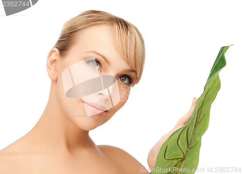 Image of woman with green leaf