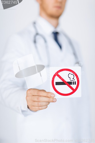 Image of male doctor holding no smoking sign