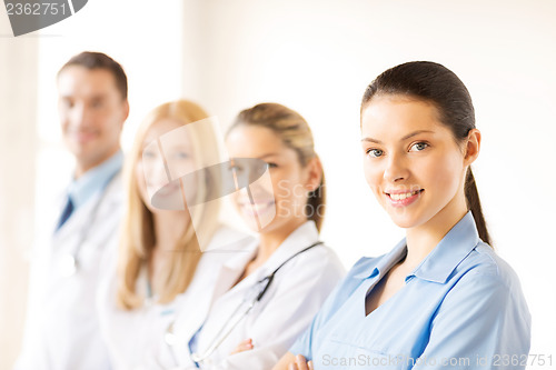 Image of female doctor in front of medical group