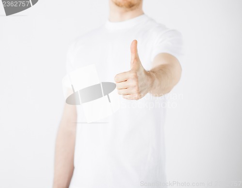 Image of man showing thumbs up