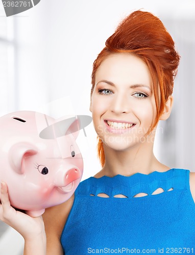 Image of lovely woman with big piggy bank