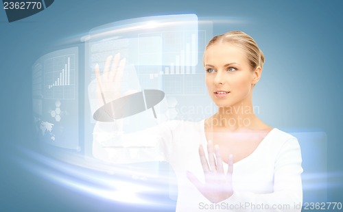 Image of businesswoman touching virtual screen