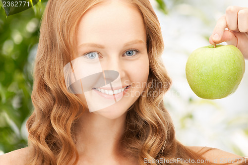 Image of young beautiful woman with green apple