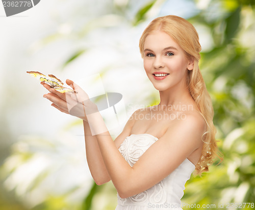 Image of woman with butterfly in hand