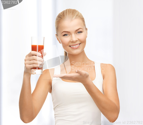 Image of woman holding glass of tomato juice