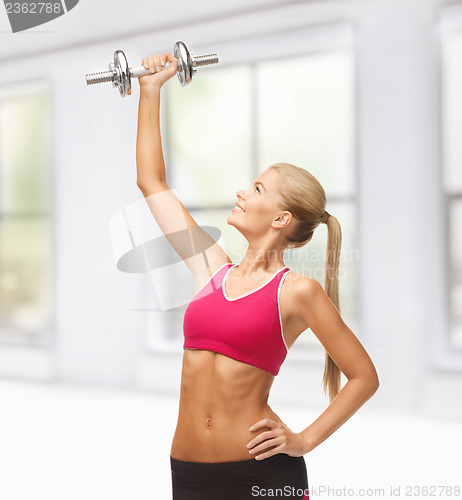 Image of woman lifting steel dumbbell