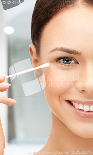 Image of beautiful woman with cotton bud