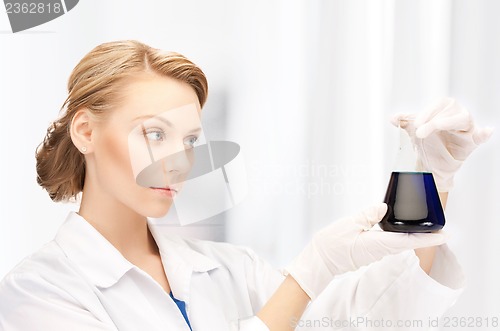 Image of female chemist holding bulb with chemicals