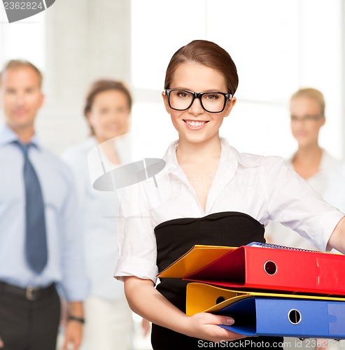 Image of young attractive businesswoman with folders