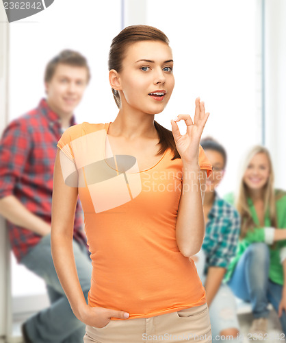 Image of woman in blank color t-shirt showing ok gesture
