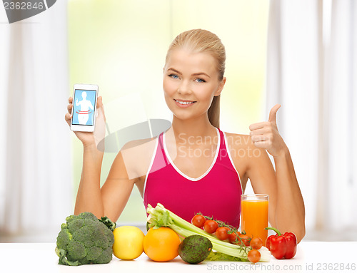 Image of woman with fruits, vegetables and smartphone