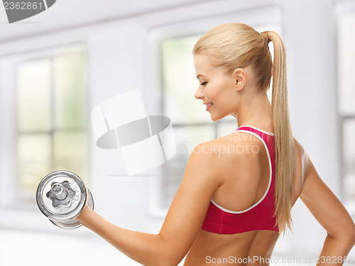 Image of woman with heavy steel dumbbell