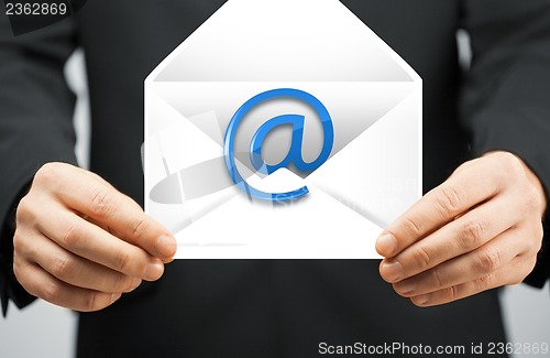 Image of man in suit holding envelope with email sign