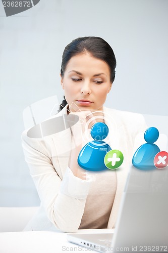 Image of woman with laptop and contact icon