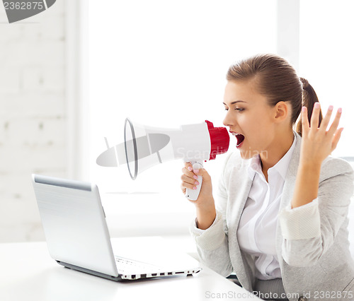 Image of strict businesswoman shouting in megaphone