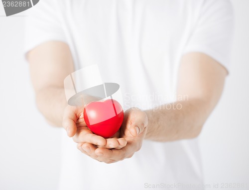 Image of man hands with heart