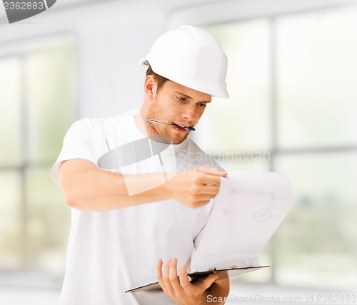 Image of male architect looking at blueprint