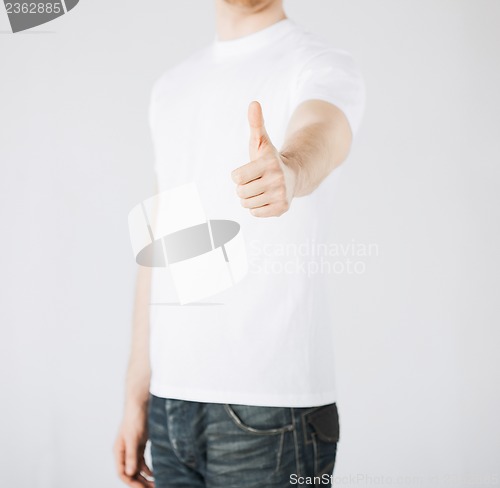 Image of man showing thumbs up