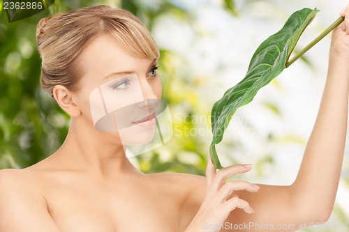 Image of woman with green leaf