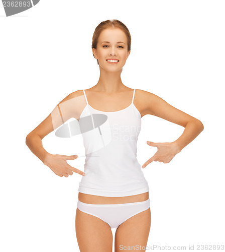 Image of woman in blank shirt pointing at her belly