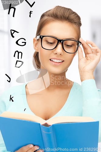 Image of woman in glasses reading book