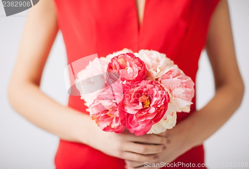 Image of woman hands with bouquet of flowers