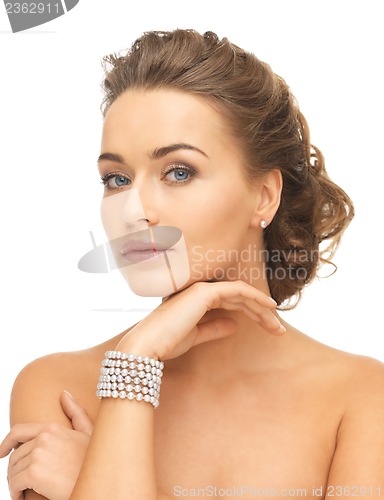 Image of woman with pearl earrings and bracelet