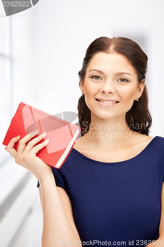 Image of happy and smiling woman with book