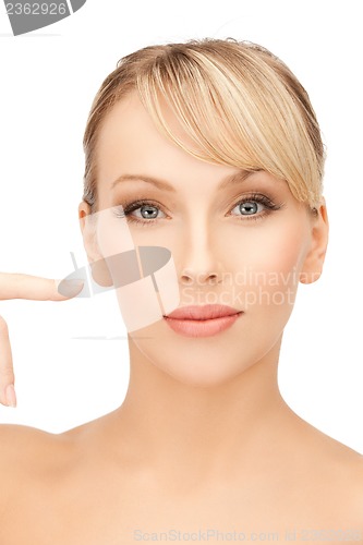 Image of woman pointing at her face