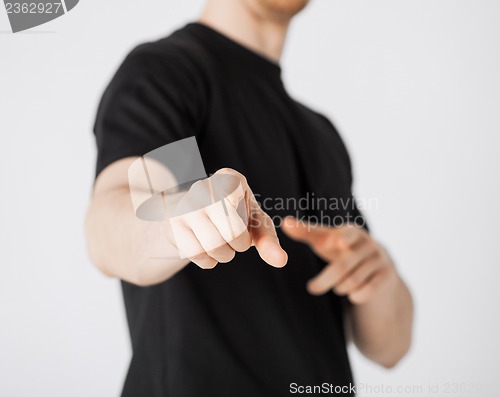 Image of man pointing his finger at you