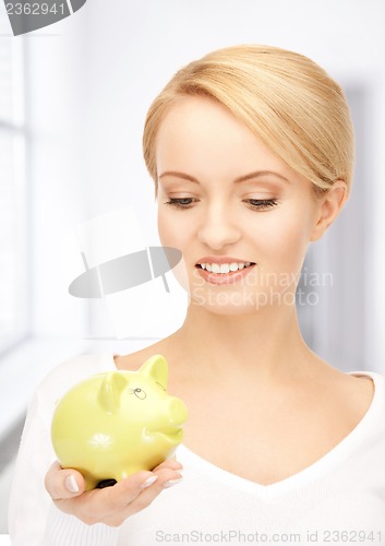 Image of lovely woman with piggy bank