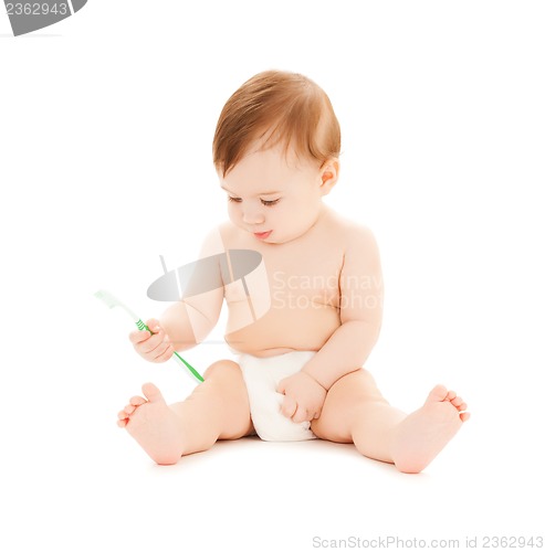 Image of curious baby brushing teeth