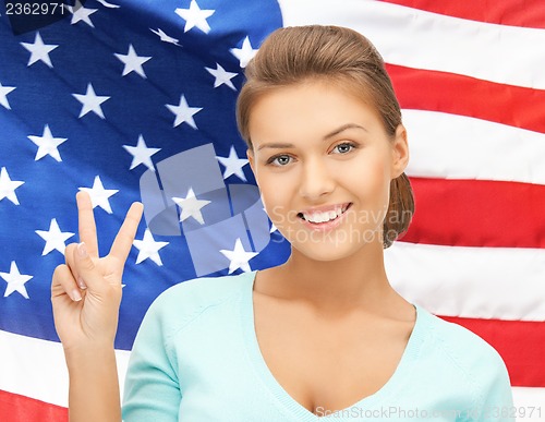 Image of young woman showing victory or peace sign