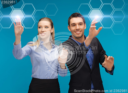 Image of man and woman working with virtual screen