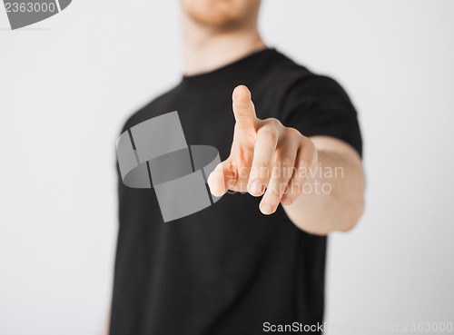 Image of man pointing his finger at you